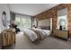 Serene main bedroom featuring warm color scheme, large windows, and patterned accent wall at 2021 Grayside Cir, Castle Rock, CO 80109