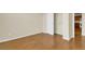 Neutral bedroom featuring wood floors, closet, and adjoining kitchen view at 8915 Federal Blvd # 104, Westminster, CO 80260