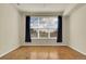 Large bedroom with hardwood floors, ceiling fan and a large window with a view at 8915 Federal Blvd # 104, Westminster, CO 80260