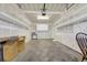 Unfinished garage with shelving, concrete floors, and garage door opener at 8915 Federal Blvd # 104, Westminster, CO 80260