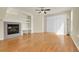 Spacious living room featuring a cozy fireplace, built-in shelves, and hardwood floors at 8915 Federal Blvd # 104, Westminster, CO 80260