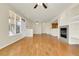 Open-concept living area with hardwood floors, fireplace and modern lighting fixtures at 8915 Federal Blvd # 104, Westminster, CO 80260