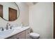 Powder room features a modern round mirror, stylish fixtures, and a new toilet at 1211 W 112Th Ave # B, Denver, CO 80234
