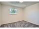 Bright bedroom features neutral paint, new carpet, and a window overlooking greenery at 1211 W 112Th Ave # B, Denver, CO 80234