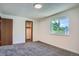 Bedroom with neutral carpet, window, and wood door at 1211 W 112Th Ave # B, Denver, CO 80234