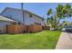 Exterior view of a well-maintained home with a lush lawn, complemented by a privacy fence at 1211 W 112Th Ave # B, Denver, CO 80234