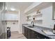 Well-lit kitchen featuring sleek granite countertops and stylish cabinets at 1211 W 112Th Ave # B, Denver, CO 80234