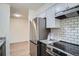 Bright kitchen features stainless appliances, white subway tile backsplash, and granite countertops at 1211 W 112Th Ave # B, Denver, CO 80234