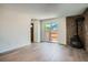 Bright living room showcasing modern floors, a cozy fireplace, and sliding door to the yard at 1211 W 112Th Ave # B, Denver, CO 80234
