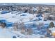 Aerial view showing the property and surrounding acreage covered in snow at 8530 W Jefferson Ave, Denver, CO 80235