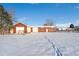 Red barn with a snow covered landscape on a sunny day at 8530 W Jefferson Ave, Denver, CO 80235