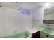 Compact bathroom features a tub/shower combination and a vintage-style sink at 8530 W Jefferson Ave, Denver, CO 80235