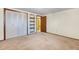 The bedroom features carpet flooring, closet and built in shelving at 8530 W Jefferson Ave, Denver, CO 80235