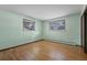 This bedroom features two windows for natural light as well as hardwood flooring at 8530 W Jefferson Ave, Denver, CO 80235