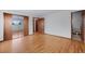 An empty bedroom features two closets, a door to an ensuite bathroom, and hardwood flooring at 8530 W Jefferson Ave, Denver, CO 80235