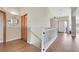 Hallway featuring wood floors and white railing leading to the upper level at 5226 S Liverpool Way, Centennial, CO 80015