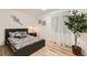 Cozy bedroom featuring a comfortable bed, natural light and hardwood floors at 5750 W Atlantic Pl, Lakewood, CO 80227
