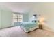 Well-lit bedroom featuring plush carpeting, and a large window at 5750 W Atlantic Pl, Lakewood, CO 80227