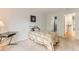 Bright carpeted bedroom with adjacent bathroom and door to hallway at 5750 W Atlantic Pl, Lakewood, CO 80227