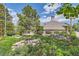 Landscaped community clubhouse with lush greenery and rock features at 5750 W Atlantic Pl, Lakewood, CO 80227