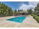 Inviting community pool with surrounding brick clubhouse and mature trees at 5750 W Atlantic Pl, Lakewood, CO 80227