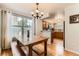 Charming dining room featuring a wooden table, bench seating, and a chandelier at 5750 W Atlantic Pl, Lakewood, CO 80227