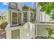 Inviting home featuring light green siding, a gated porch, and an arched front door at 5750 W Atlantic Pl, Lakewood, CO 80227