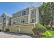 Stylish townhome showcasing a two car garage and manicured green landscaping at 5750 W Atlantic Pl, Lakewood, CO 80227