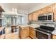 Bright kitchen featuring wooden cabinets, stainless steel appliances, and hardwood floors at 5750 W Atlantic Pl, Lakewood, CO 80227