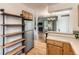 Kitchen and open layout of dining area with refrigerator and wooden shelving at 5750 W Atlantic Pl, Lakewood, CO 80227