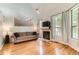 Bright living room featuring hardwood floors, a fireplace, and large windows at 5750 W Atlantic Pl, Lakewood, CO 80227