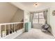 Bright sitting area features soft natural light through large windows, accent cabinet, and comfortable seating at 5750 W Atlantic Pl, Lakewood, CO 80227