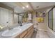 Bathroom features double sinks, tile floor, shower with glass enclosure, and ample storage at 6251 S Iola Ct, Englewood, CO 80111