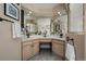 Bathroom with double vanity, neutral tile, ample lighting, and plenty of counter space at 6251 S Iola Ct, Englewood, CO 80111