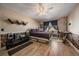 Cozy bedroom with hardwood floors, ceiling fan, and unique brick-style wainscoting detail at 6251 S Iola Ct, Englewood, CO 80111