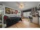 Interesting bedroom with hardwood floor, decorative ceiling fan, and unique black and white decor at 6251 S Iola Ct, Englewood, CO 80111