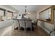 Bright dining room featuring hardwood floors, a modern chandelier, and a large mirror reflecting natural light at 6251 S Iola Ct, Englewood, CO 80111