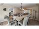 Elegant dining room featuring hardwood floors, stylish chandelier, and view of the kitchen at 6251 S Iola Ct, Englewood, CO 80111