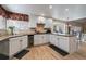 Bright kitchen with white cabinets, granite countertops, stainless steel appliances, and wine cooler at 6251 S Iola Ct, Englewood, CO 80111