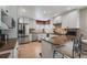 Kitchen featuring stainless steel appliances, white cabinetry, granite countertops, and breakfast bar seating at 6251 S Iola Ct, Englewood, CO 80111