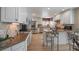 Spacious kitchen with granite countertops, white cabinetry, stainless steel appliances, and an island with bar seating at 6251 S Iola Ct, Englewood, CO 80111