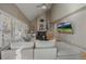 Cozy living room featuring a fireplace, large windows with shutters, and a plush sectional sofa at 6251 S Iola Ct, Englewood, CO 80111