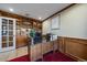 Home office with custom built-in bookshelves, hardwood floors, and a view of the backyard at 6251 S Iola Ct, Englewood, CO 80111