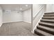 Finished basement with carpeted floors and stairs, and natural light at 15875 E Custer Dr, Aurora, CO 80017
