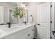 Bright bathroom featuring dual sinks with matte black fixtures and a white vanity at 15875 E Custer Dr, Aurora, CO 80017