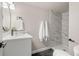 Renovated bathroom featuring a walk-in shower and a modern vanity at 15875 E Custer Dr, Aurora, CO 80017