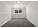 Clean bedroom with carpeted floors, a window, and a spacious closet at 15875 E Custer Dr, Aurora, CO 80017