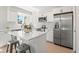 Modern kitchen with stainless steel appliances, a center island, and white cabinets at 15875 E Custer Dr, Aurora, CO 80017