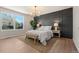 Beautiful main bedroom with accent wall, chandelier lighting, and lots of natural light at 15875 E Custer Dr, Aurora, CO 80017