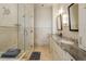 Elegant bathroom featuring a double vanity, marble tile and a glass shower at 5455 Landmark Pl # 1009, Greenwood Village, CO 80111